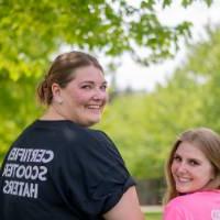 Cornhole team with matching pink and black shirts